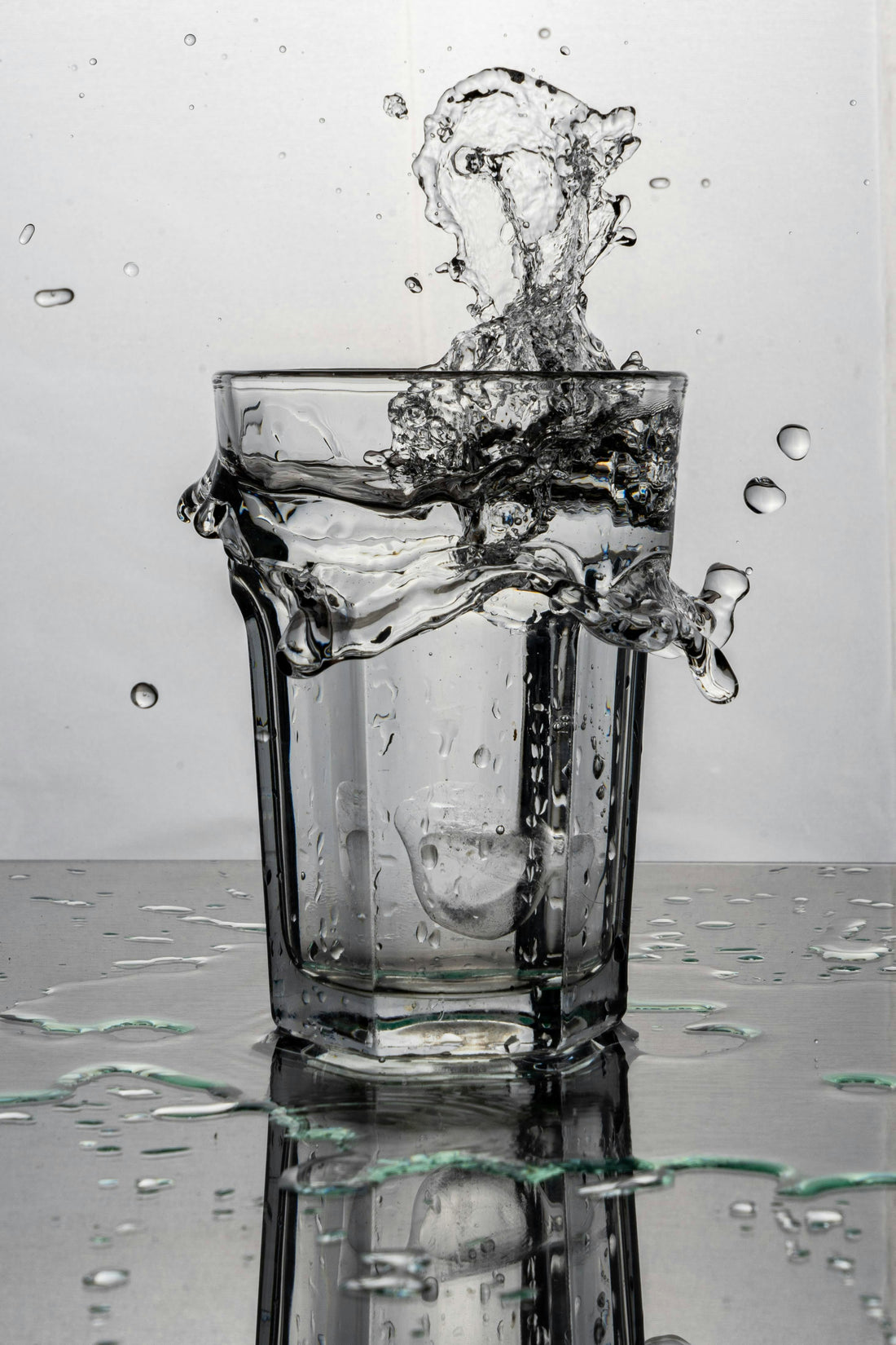 Glass of splashing water. Photo by Nicolas Ruiz on Unsplash